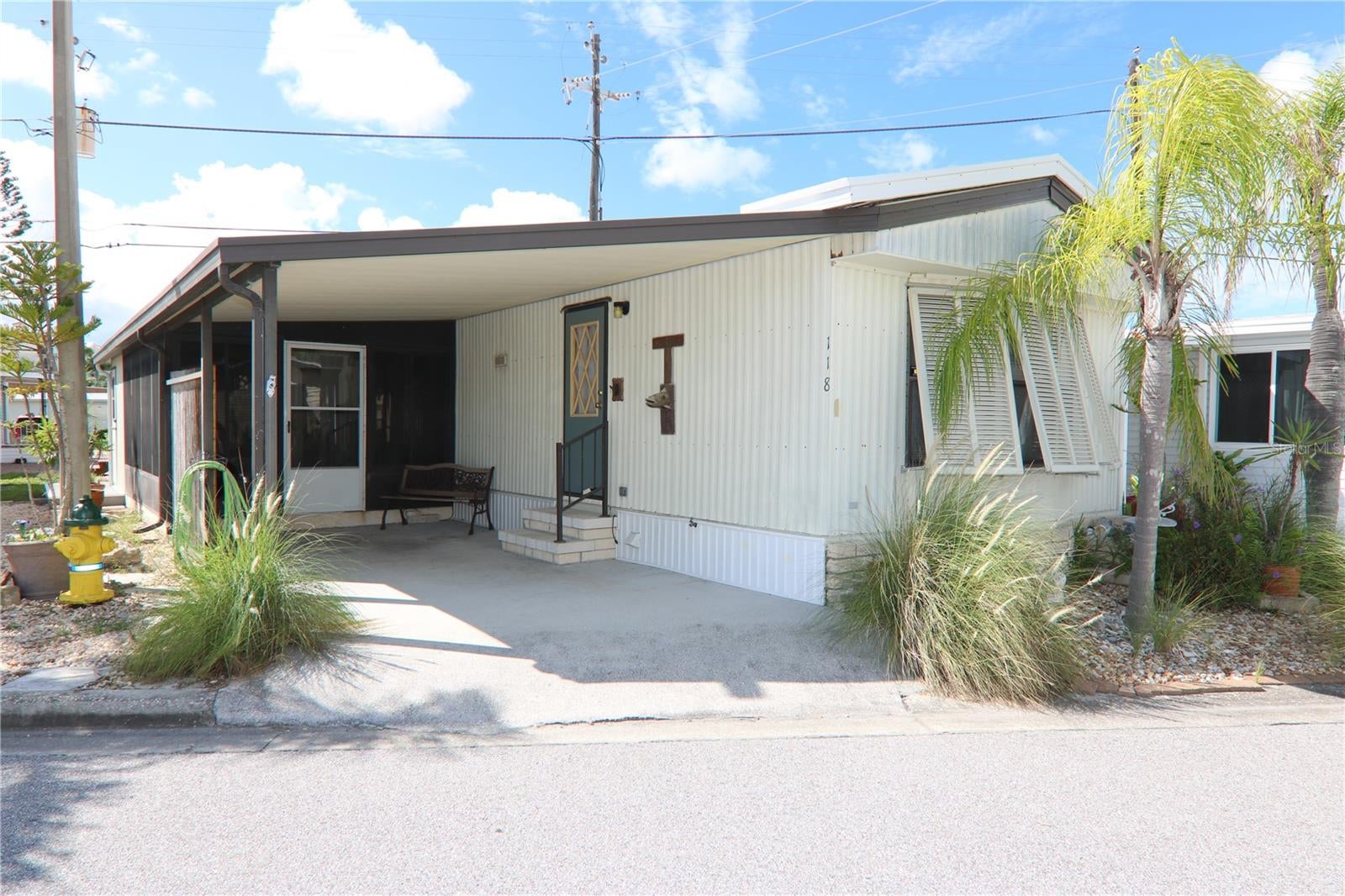 Your Florida Dream Awaits! Fantastic opportunity to own in the desirable community of Harbor Lights! Located just under 1 mile from Historic Downtown Venice and the Gulf Coast beaches, this unbeatable location offers the best of Florida living. Harbor Lights features excellent amenities including a community pool, pickleball/tennis court, and a clubhouse with year-round activities. This 2-bedroom, 1-bathroom home is ready for a new owner to make it their own. The open-concept layout combines the living, dining, and kitchen areas, with a convenient breakfast bar and a light, bright living space. A large screened lanai off the carport provides additional room to relax or entertain. The washer and dryer are conveniently located just off the kitchen. Recent updates include a newer metal roof (2020) and newer HVAC system (2022). A storage/workshop area off the lanai adds extra functionality, and the newer back deck is perfect for enjoying the Florida sunshine. Harbor Lights offers maintenance-free living with included lawn care and low fees. Best of all — you own the land with NO lot rent! Schedule your showing today!