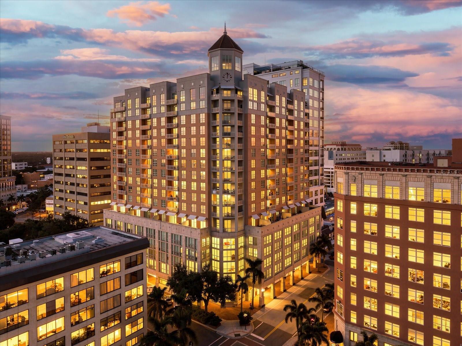 Experience downtown Sarasota living from this spacious 2-bedroom, 2.5-bath penthouse at 1350 Main, featuring two private terraces with elevated city and pool views, two deeded parking spaces, and an exceptional location in the heart of Sarasota's cultural and culinary district. With restaurants, boutiques, art galleries, theaters, and waterfront attractions just moments away, this residence offers the convenience of a walkable downtown lifestyle. Inside, 10-foot ceilings and expansive windows fill the open-concept living and dining areas with natural light, complemented by engineered hardwood flooring, motorized shades on all sliding glass doors, and a remarkably quiet interior. One terrace is accessible from the living and dining areas, while the second is privately accessed from the oversized primary suite, which also offers space for a sitting area or home office, a custom walk-in closet, and an en-suite bathroom with dual vanities, soaking tub, and separate shower. The kitchen features natural stone countertops, KitchenAid appliances, an 8-burner gas range with double ovens, generous cabinetry, and convenient pull-out cabinet shelving. The second bedroom includes an en-suite bath and walk-in closet. Recent improvements include fresh interior paint, removal of select built-ins, a new chandelier in the entryway, and professional cleaning. A separate storage locker adds valuable convenience. Residents of 1350 Main enjoy 24-hour concierge service, a newly completed pool deck with additional outdoor furnishings planned, heated pool and spa, fitness center, clubhouse, billiards, meeting rooms, outdoor grilling areas, and a reservable guest suite. Walk to Sarasota Opera House, Florida Studio Theatre, Main Street dining and shopping, Bayfront Park, Marina Jack, and O'Leary's Tiki Bar & Grill. Whether enjoying Sarasota year-round or as a seasonal retreat, Penthouse 1703 offers an appealing combination of space, privacy, amenities, and one of downtown Sarasota's most desirable locations.