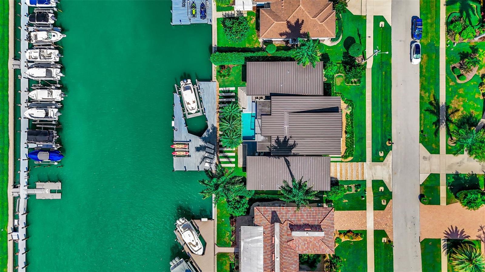 Designed for entertaining and built for the ultimate Marco Island boating lifestyle, 870 Partridge Court is a waterfront residence unlike anything else on the island. Positioned on a 125’ wide canal with direct Gulf access just moments away, the property features a private dock and 30,000 lb boat lift accommodating vessels up to 42 feet. Inside, dramatic exposed steel I-beams, poured concrete construction, polished concrete floors and nearly $400,000 in hurricane-impact glass and specialty doors create a striking combination of modern architecture and remarkable structural integrity. Soaring 16-foot ceilings and walls of glass frame the water, while expansive accordion doors open the main living area completely to the pool and waterfront terrace—creating one seamless space for entertaining. The 2,866-square-foot residence offers three bedrooms plus a flexible office/den, a chef’s kitchen, spa-inspired baths and integrated whole-home audio, security and technology. Nearly every room is oriented toward the water and outdoor living. From your backyard, cruise to the Gulf, Keewaydin Island and the Ten Thousand Islands, then return home for sunset by the pool. Bold architecture, serious boating capability and effortless indoor-outdoor living come together in one exceptional Marco Island residence. 870 Partridge Court isn’t simply another waterfront home—it’s a modern luxury stronghold built around life on the water.