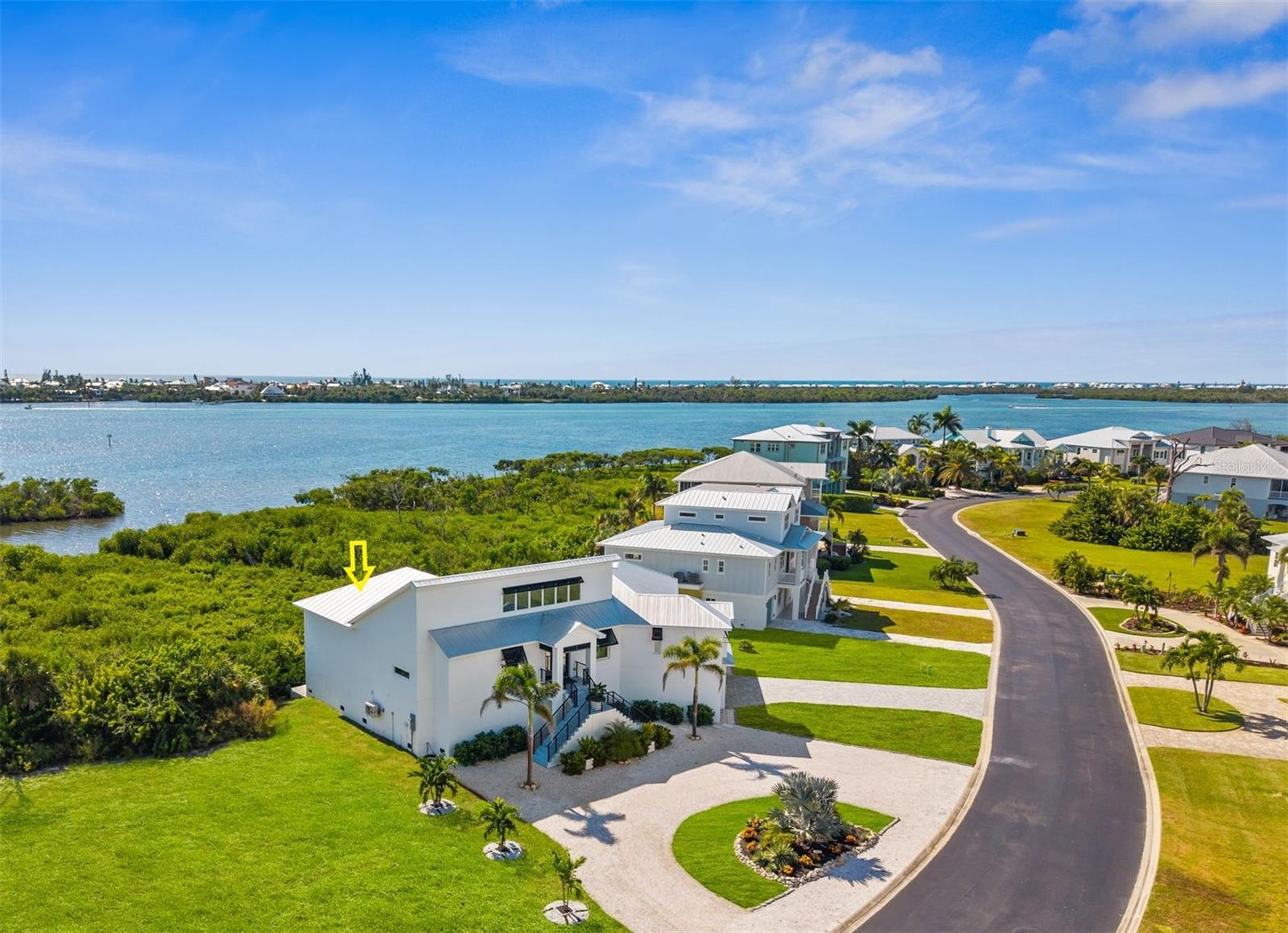 Experience exceptional coastal living in this custom 2023 home in the gated Eagle Preserve Estates, set between Lemon Bay Golf Course and Lemon Bay. This elevated residence offers 3 en-suite bedrooms, 3.5 baths, a metal roof, and an oversized 2-car garage with bonus golf cart/storage space. CLICK ON THE VIRTUAL TOUR LINK 1 FOR THE VIDEO AND VIRTUAL LINK 2 FOR THE 3D TOUR. Designed for effortless indoor-outdoor entertaining, the 19’x30’ heated pool & hot tub with a swim-up dry bar create a true resort-style experience. Spanning the entire back of the home, the 68’x24’ screened lanai overlooks the mangroves and bay, delivering peaceful water and nature views from every bedroom. Inside, soaring ceilings, expansive glass, and natural light frame the open living spaces. The CHEF-INSPIRED kitchen is the centerpiece of the home with touch-to-open cabinetry, a 13-ft island with stainless prep counter and raised bar, quartz surfaces, induction cooktop, built-in convection French-door oven, and a coffee/wine bar with beverage fridge—ideal for gatherings of any size. Additional features include a tankless water heater, conveying washer/dryer, and included kitchen stools and outdoor furnishings. Enjoy newer construction, nearby marinas, and quick access to beaches, dining, golf, and boating. Golf membership is optional. Schedule your showing TODAY!