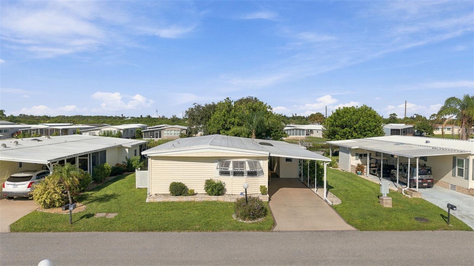 Welcome to Lazy River Village! One of the premiere 55+ waterfront manufactured parks in all of Sarasota and Charlotte Counties! The BEST amenities, clubs, and selection of activities you will find in any co-op park. Lazy River is located on the banks of the beautiful Myakka River. Florida wildlife surrounds you! This STUNNING WATERFRONT ACCESS home with BOATING access will have you dreaming of "Florida living" at its best.  This home welcomes you into a bright living space where form and function combine seamlessly. Laminate flooring throughout the house. The kitchen has all major appliances and a convenient breakfast bar for casual meals. Combined living room/dining room. The primary bedroom has an ensuite bathroom with DUAL SINKS and built-in closets. Second bedroom also has a built-in closet. A large enclosed Florida room offers VERSATILE space for relaxing, entertaining, or hobbies and looks out over the water. This WATERFRONT home has a dock that overlooks the canal which empties into the Myakka River. NEW 2023 membrane roof! This home is the perfect seasonal place to enjoy Florida's coveted gorgeous winters and a perfect year-round home for those who love all 4 seasons of Florida. If you enjoy an abundance of activities, you will have plenty to choose from in Lazy River Village: Pickleball, tennis, bike clubs, card clubs, and pontoon boating. They even have a professional woodworking shop. A low monthly fee of $288 includes all the amenities. There are other amenities for an extra fee, such as a marina slip if your home is not located on the water. One of the things that makes Lazy River Village so great is its proximity to...well...everything! Be prepared to enjoy Florida's wildlife at its finest, both inside the Lazy River Village complex and at abundant state parks and nature preserves. Shopping and dining surround you in all directions. The spring training homes of both the Atlanta Braves & the Tampa Bay Rays are just a minutes away. The world-renowned Gulf of Mexico beaches are all within 30 minutes or less! 1) Englewood beach, 2) Casperson Beach (GREAT for shelling), 3) Venice Beach (shark tooth capital of the world), 4) Brohard Paw Park, 5) Nokomis beach (you've GOT to experience the weekly drum circles), 6) the island gem of southwest Florida: Boca Grande... And finally: 7) Siesta Key in Sarasota has been ranked multiple times as the number one beach in the nation and is a mere 35 minutes away. Lazy River Village offers a lifestyle that every retiree dreams of. You have the quaint downtowns of Venice and Punta Gorda--both cities are often ranked as Top 10 destinations in the country for retirement. Another local favorite, Englewood, is a cozy, fun beach town on the Gulf of Mexico. The residents of Lazy River Village agree: Lazy River is a community that offers it all. Don't miss your chance to see this home!