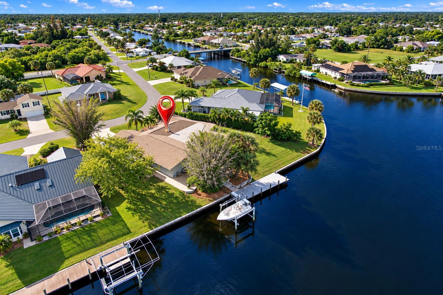 LOCATION,LOCATION,LOCATION Sailboat/Yacht access and to immediate deep water. This house offers the perfect blend of comfort and functionality. The VEIWS are amazing from every room. If seclusion is important, looking for your private oasis, you found it. it has 163 feet seawall, 13,000 lb boatlift with plenty of room to add more. it has a huge lanai and 20,000 gal + pool. NO HOAs . Enjoy some of the most fantastic sun rises and enjoy the sun setting to you back, plenty of shade. Has an additional drive to park any oversized RV or boat, with elec hook up. DONT MISS THIS OPPERTUNTY to have amazing views, very fast access to open water.