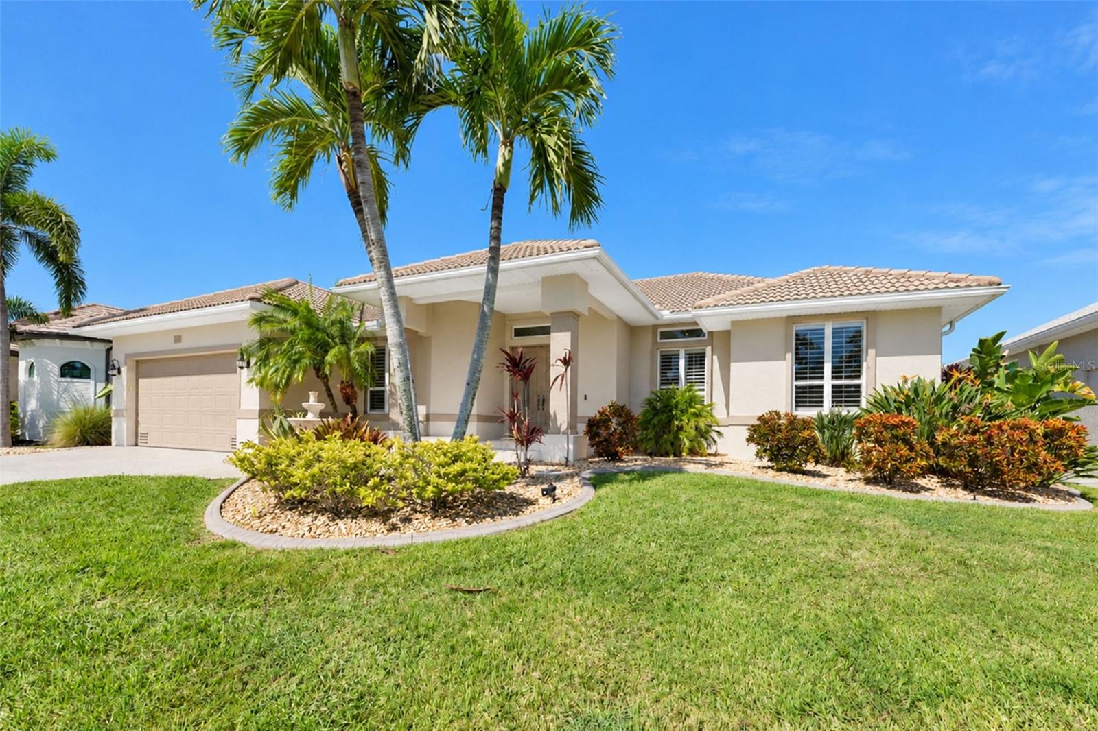 Virtually Staged. WATERFRONT LIVING AT ITS BEST! Enjoy the ultimate Southwest Florida lifestyle in this beautifully maintained 3-bedroom, 2-bath home with a 2-car garage in desirable Burnt Store Isles. Boaters will love the beautifully paver walkway to 45-foot private dock with a 13,000-pound electric boat lift, water, electric, and a 30-amp outlet, offering access to Charlotte Harbor and beyond. Back on shore, unwind in your private outdoor retreat featuring a saltwater pool with waterfall, therapeutic spa, and peaceful canal views with stunning sunsets.
The open floor plan is designed for effortless entertaining, with 16 feet of pocketing sliders opening to the expansive lanai for seamless indoor-outdoor living. The kitchen features KitchenAid stainless steel appliances and double ovens, while thoughtful upgrades throughout enhance comfort and convenience.
Built to post-2005 hurricane codes, the home offers added peace of mind with hurricane accordion shutters, remote-controlled hurricane and privacy screens, and remote-controlled blackout shades. Additional improvements include a Trane A/C, Rheem Performance Platinum water heater, water-softening systems, pool and spa heating with Pentair automation, and polyaspartic-coated pool deck, driveway, front walkway and garage floor.
Ideally located near marinas, golf courses, waterfront dining, Fishermen’s Village, and historic downtown Punta Gorda, this property combines boating convenience, outdoor enjoyment, and everyday accessibility. Optional Twin Isles Country Club membership offers additional golfing and social opportunities.
Your private waterfront retreat is ready for you to enjoy—whether as a full-time residence or a seasonal escape.