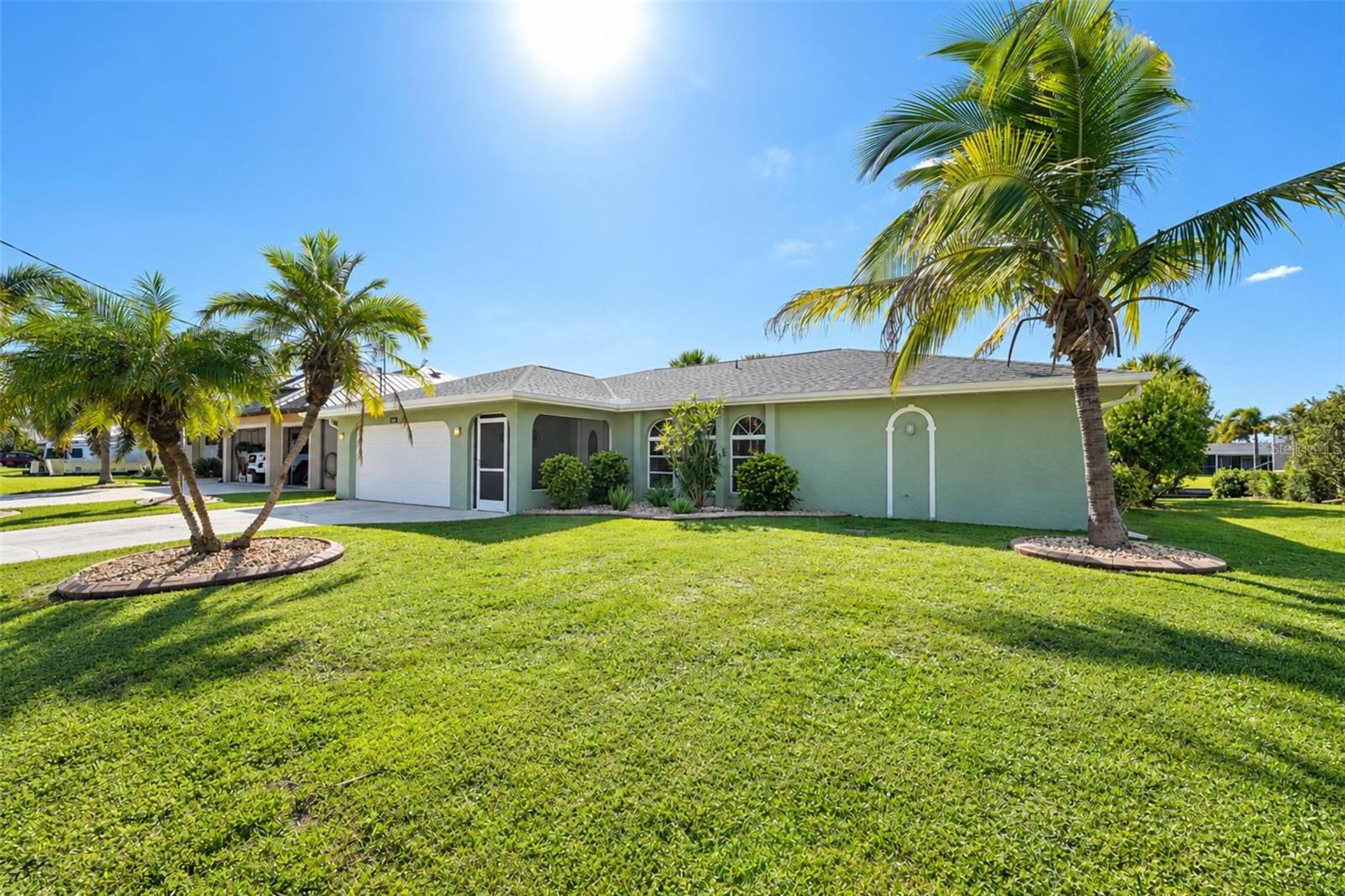 Discover a relaxed waterfront lifestyle at 18231 Hottelet Circle, where peaceful canal views, a private backyard, and inviting indoor spaces come together. This three-bedroom, two-bath, 2 car garage home features a split-bedroom floor plan, with the primary bedroom privately positioned on one side and two spacious bedrooms on the other—offering a comfortable sense of separation for family and visitors.

The recently upgraded kitchen pairs beautiful quartz countertops with abundant neutral-toned cabinetry and generous workspace for meal preparation, serving, and gathering. The newly designed laundry room adds everyday convenience with extensive cabinetry and countertops to help keep household essentials organized.

Step outside to a spacious pool deck overlooking the saltwater canal, with plenty of room to lounge, dine, or entertain. The westerly exposure sets the scene for gorgeous sunsets over the water. For boating enthusiasts, the property includes a 10,000-pound boat lift and davits, with one bridge along the canal route. Beyond the pool, the private backyard offers a tropical touch with mango and lime trees and pineapple plants. Pool has been resurfaced. 

An audio system extends throughout the home and onto the lanai, making it easy to enjoy music as you move between indoor and outdoor living. 
From peaceful mornings by the canal to sunset evenings beside the pool, this home offers a welcoming place to enjoy the Florida waterfront lifestyle.