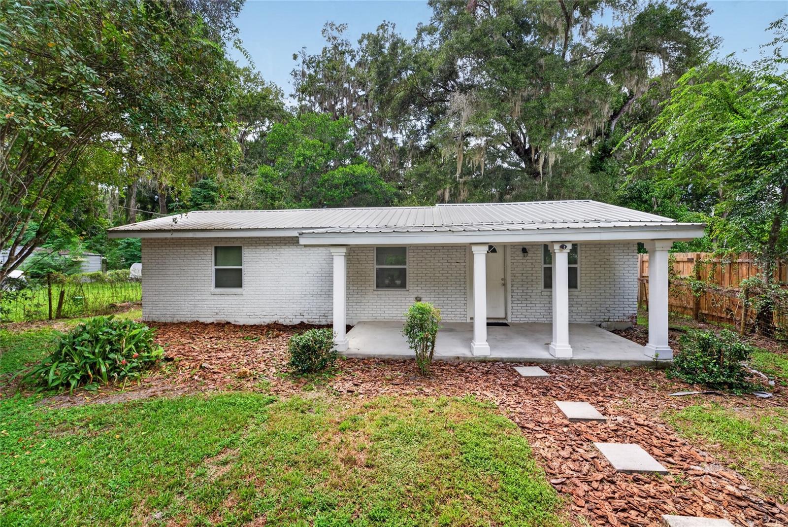 Charm meets modern comfort in this stunning renovated home.. Every detail has been thoughtfully updated, giving you the peace of mind of a like-new home with all the character of an established neighborhood. Step inside to find gorgeous new flooring flowing throughout, a beautifully redesigned bathroom featuring custom tile work, and a spacious family room that's perfect for cozy nights in or entertaining friends and family. A durable metal roof and energy-efficient double-pane windows offer worry-free living for years to come, while fresh paint inside and out gives the home a crisp, move-in-ready feel. Unwind on either of the charming covered front and rear porches, or head out back to your private oasis—a generous, tree-shaded yard offering the perfect setting for weekend barbecues, morning coffee, or simply soaking up the outdoors. Ideally located within walking distance to Williston's local shops and restaurants, this home offers the best of both comfort and convenience. With everything renovated in 2020, all that's left to do is move in and make it yours!
