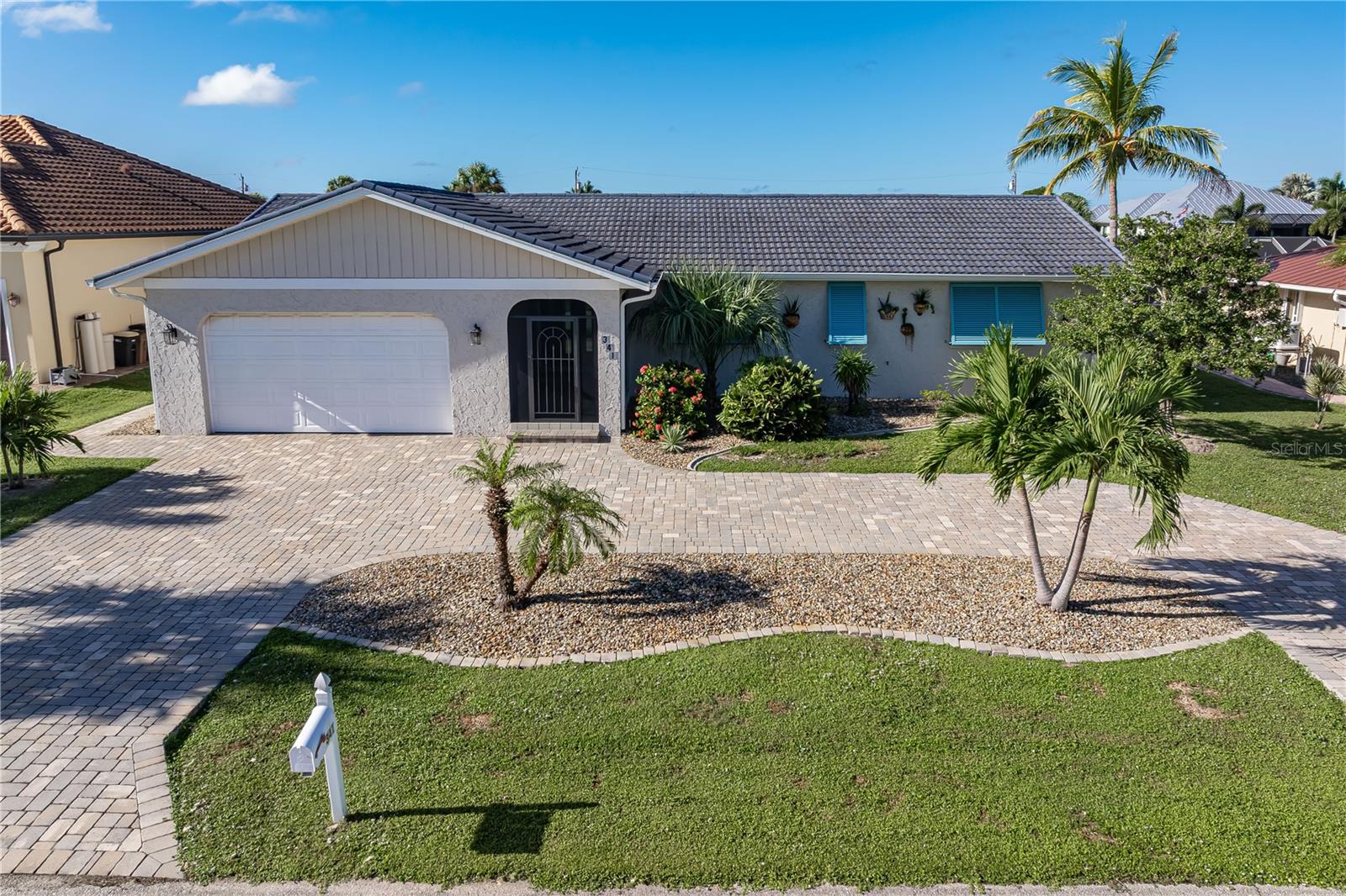 UPDATED INSIDE. PARADISE OUTSIDE! This beautifully updated, 3 bed/2 bath waterfront pool home in Punta Gorda Isles offers 1,809 sq ft of living space, 85 FT OF SEAWALL & QUICK BOATING ACCESS TO CHARLOTTE HARBOR IN UNDER 15 MINUTES! Located at the end of a short cul-de-sac street, this home features a circular paver driveway, tropical landscaping & an oversized two-car garage. Inside, the spacious, open living/dining area features recessed lighting, neutral colors & two sets of sliding glass doors (five panels total) that connect the interior to the lanai. With the front door open to the screened entry & the sliders open to the lanai, refreshing tropical cross breezes flow through the home. Architectural details include wood-look ceramic plank tile flooring throughout the home & modern ceiling fans. Recent improvements include hurricane-rated sliding glass doors & kitchen window (2024), hurricane Bahama shutters & a hurricane-rated front entry door (2025). The updated kitchen boasts granite counters, KraftMaid cabinetry, stainless steel appliances, a NEW INDUCTION RANGE & TILE BACKSPLASH (2025), recessed lighting & a peninsula breakfast bar. A window over the kitchen sink offers a lovely canal view. Just off the kitchen is a BONUS ROOM currently used as a home office/sewing room, perfect for crafts, hobbies or a private workspace. The spacious master suite features TWO WALK-IN CLOSETS & an updated en-suite bath w/granite vanity, oversized tiled walk-in shower & linen closet. Two guest bedrooms share an updated guest bath. Additional improvements include a NEW WATER HEATER (2022) & updated fixtures throughout. OUTDOOR LIVING IS WHERE THIS HOME REALLY SHINES! The oversized, screened lanai is thoughtfully designed to provide the perfect balance of shade & sunshine. Thanks to the unique angle of the covered lanai, the outdoor seating & dining areas stay shaded while the sparkling pool enjoys the Florida sunshine. It's the BEST OF BOTH WORLDS! The southwest rear exposure offers beautiful evening skies over the canal. Enjoy multiple seating areas, ceiling fans, string lighting & a spacious paver pool deck. A separate brick paver patio just outside the lanai provides another spot to sit outdoors and enjoy the backyard. Whether entertaining friends, dining outdoors or relaxing poolside, this space was designed for year-round Florida living. The pool enclosure features ALL NEW SCREENING (2024), updated doors & fresh paint. Other improvements include a NEW POOL PUMP (2024) & TWO REMOTE-CONTROLLED KEVLAR HURRICANE SCREENS on the lanai. Boaters will appreciate the 85 FT OF SEAWALL & concrete dock w/boat lift, plus new dock pilings & bumper poles (2024). A curved paver walkway leads from the lanai to the dock, passing through a well-maintained lawn accented by tropical palms & landscaped planting beds. Reach Charlotte Harbor in 15 minutes or less for fishing, boating & exploring SW Florida's coastal destinations. Punta Gorda Isles offers an active waterfront lifestyle close to Fishermen's Village, Isles Yacht Club, parks & historic downtown Punta Gorda. Enjoy waterfront dining, boutique shopping & community events, all just a short walk or bike ride away. There is NO MANDATORY HOA, but residents have the option to join the Punta Gorda Isles Civic Association (PGICA), offering social memberships, a variety of clubs & sponsored activities. Make an appointment today & start living your Florida dream! PROPERTY AVAILABLE TURNKEY/FURNITURE NEGOTIABLE.
