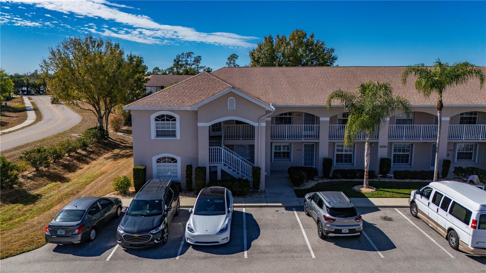 Welcome to this beautiful 3-bedroom, 2-bath condo, Deeded Garage Included in the Crystal Bay community, perfectly located and ready for you to move right in. This second-floor end unit offers extra privacy, great natural light, and high ceilings that make the space feel open and airy. The condo comes fully furnished with tasteful décor and new light fixtures, so you can settle in without lifting a finger. The open kitchen features ample cabinet storage and flows easily into the main living area—ideal for everyday living or entertaining. Step into the enclosed lanai to enjoy a peaceful retreat with added privacy. All bedrooms are generously sized, with the primary suite offering walk-in closets, tile-inlay showers, and matching vanities in the bathrooms for a clean, cohesive look. An updated HVAC system adds peace of mind, and a deeded garage is included for convenience. Enjoy quick access to the community pool, along with well-lit sidewalks, outdoor lighting, and underground utilities throughout the neighborhood. Crystal Bay is known for its desirable location, offering easy access to local shopping, dining, and everyday amenities. This move-in-ready condo checks all the boxes—comfort, style, and location.