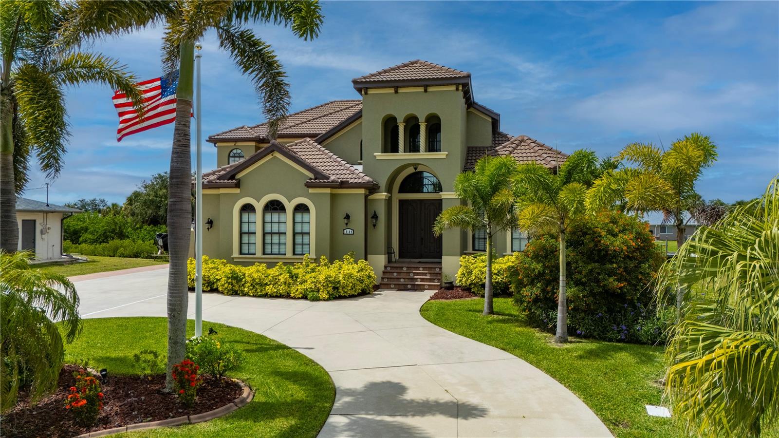 Waterfront luxury, effortless boating, and exceptional craftsmanship come together in this custom-built waterfront estate in the highly sought-after Port Charlotte Beach area. Featuring sailboat access with no fixed bridges, 80 feet of waterfront frontage, a private 60-foot dock, and a 24,000-pound boat lift, this Gulf-access home offers direct boating access to Charlotte Harbor and beyond. Designed for those who appreciate both luxury and the waterfront lifestyle, this exceptional Port Charlotte waterfront home combines elegant living, outstanding boating amenities, and a prime location near Punta Gorda. Featuring 4 bedrooms, 4.5 bathrooms, and a 3 car garage, this luxury residence blends elegant design with everyday comfort. Inside, soaring ceilings, arched architectural details, stately columns, crown molding, plantation shutters, and abundant natural light create an inviting atmosphere throughout. A double-sided gas fireplace serves both the formal dining room and private office, adding warmth and character to the living spaces. The gourmet kitchen is designed to impress, featuring solid wood cabinetry, granite countertops, stainless steel appliances, an induction cooktop, built-in oven and microwave, warming drawer, wine bar, and wine refrigerator. Ideal for entertaining, the open layout seamlessly connects the kitchen to the home's main living areas. The first-floor primary suite offers a private retreat complete with a spacious walk-in closet and a spa-inspired bathroom featuring a jetted soaking tub, dual vanities, and a Roman-style multi-head shower. Upstairs, three oversized guest bedrooms and two full baths provide ample space for family and visitors. One bedroom includes an en suite bath, while two additional bedrooms share a Jack-and-Jill bathroom. A private loft with balcony overlooks the pool area and offers flexible space for a home office, media room, or relaxation area. Step outside to your own tropical oasis. The expansive screened lanai features a heated saltwater pool, paver decking, lush landscaping, and a custom tiki hut with a fully equipped outdoor kitchen, creating the perfect setting for entertaining, waterfront dining, and enjoying Southwest Florida's year-round sunshine. Recent upgrades provide exceptional value and peace of mind, including a new tile roof (2022), impact-resistant windows, new zoned A/C systems, new pool heater, pump and salt system, new carpeting, and fresh interior and exterior paint. Additional highlights include a circular paver driveway, side-loading 3-car garage, no HOA, no deed restrictions, and no flooding or hurricane damage from past storms. Conveniently located near Port Charlotte Beach Park, the Sunseeker Resort Charlotte Harbor, golf courses, waterfront dining, shopping, Charlotte Harbor, Downtown Punta Gorda, I-75, and Punta Gorda Airport, this move-in-ready waterfront property offers luxury, location, and direct boating access in one extraordinary package.