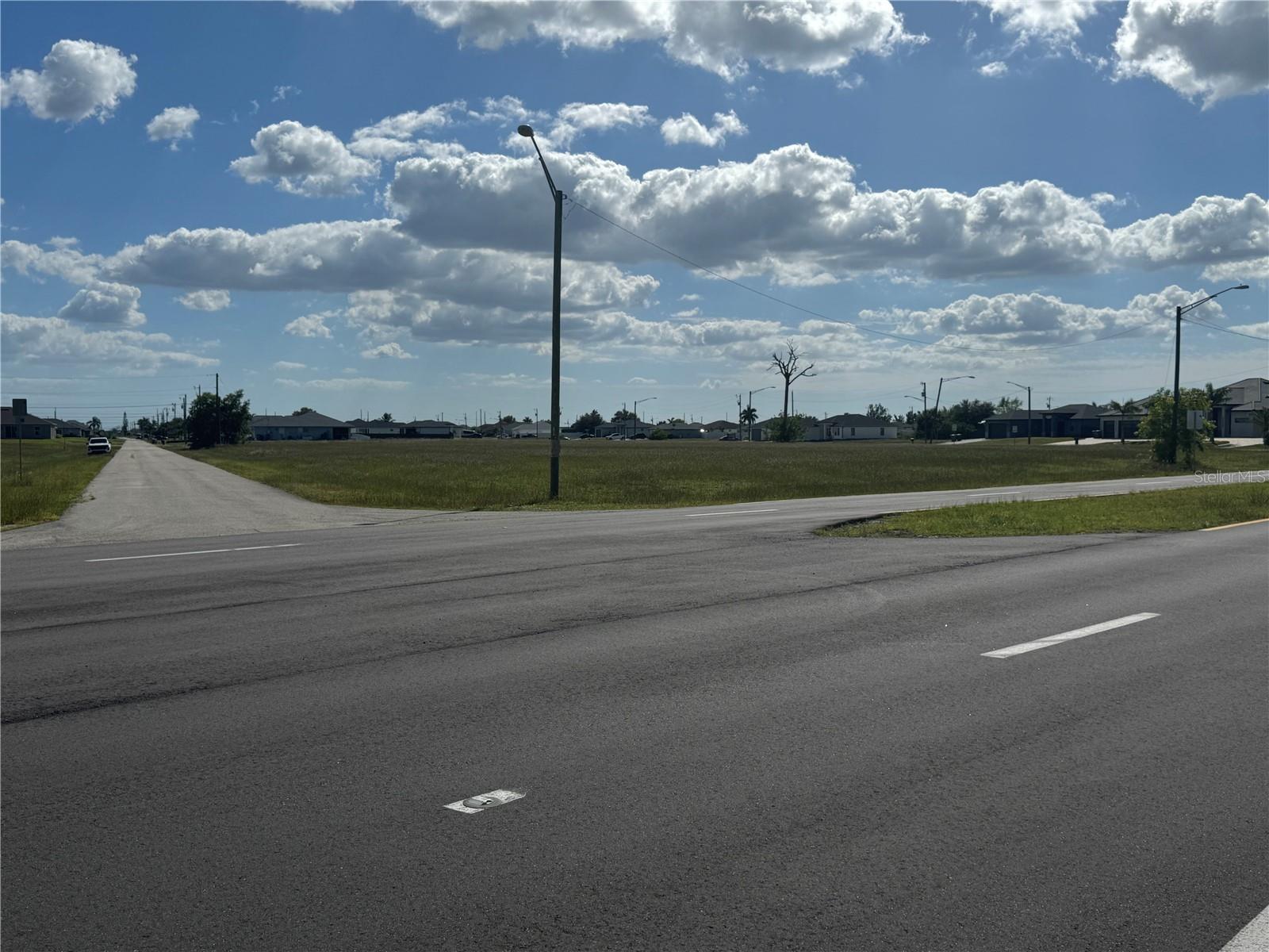 Unlock the potential of this prime corner lot located at 3030 NW 7th Place in the heart of a rapidly developing Cape Coral corridor. Spanning approximately 0.33 acres (14,250 sq. ft.), this versatile property offers a rare opportunity for both investors and visionaries. With C-zoning in place, the possibilities are vast—ranging from a custom-built residence to a strategic commercial venture such as retail, professional office space, or a service-oriented establishment. Positioned perfectly near the intersection of Pine Island Road and US-41, this location puts you right in the center of the action. You’ll be minutes away from an array of shopping centers, diverse dining options, medical facilities, and local parks. The lot features paved road access with electricity nearby, making the initial stages of development that much smoother. Plus, sitting in Flood Zone X means you can build with confidence, as flood insurance is typically not required. This oversized corner parcel provides excellent visibility and plenty of room to bring your architectural goals to life. Whether you are looking to plant roots in a growing neighborhood or expand your commercial portfolio, this lot represents a smart, high-potential investment in one of Florida’s most dynamic cities.