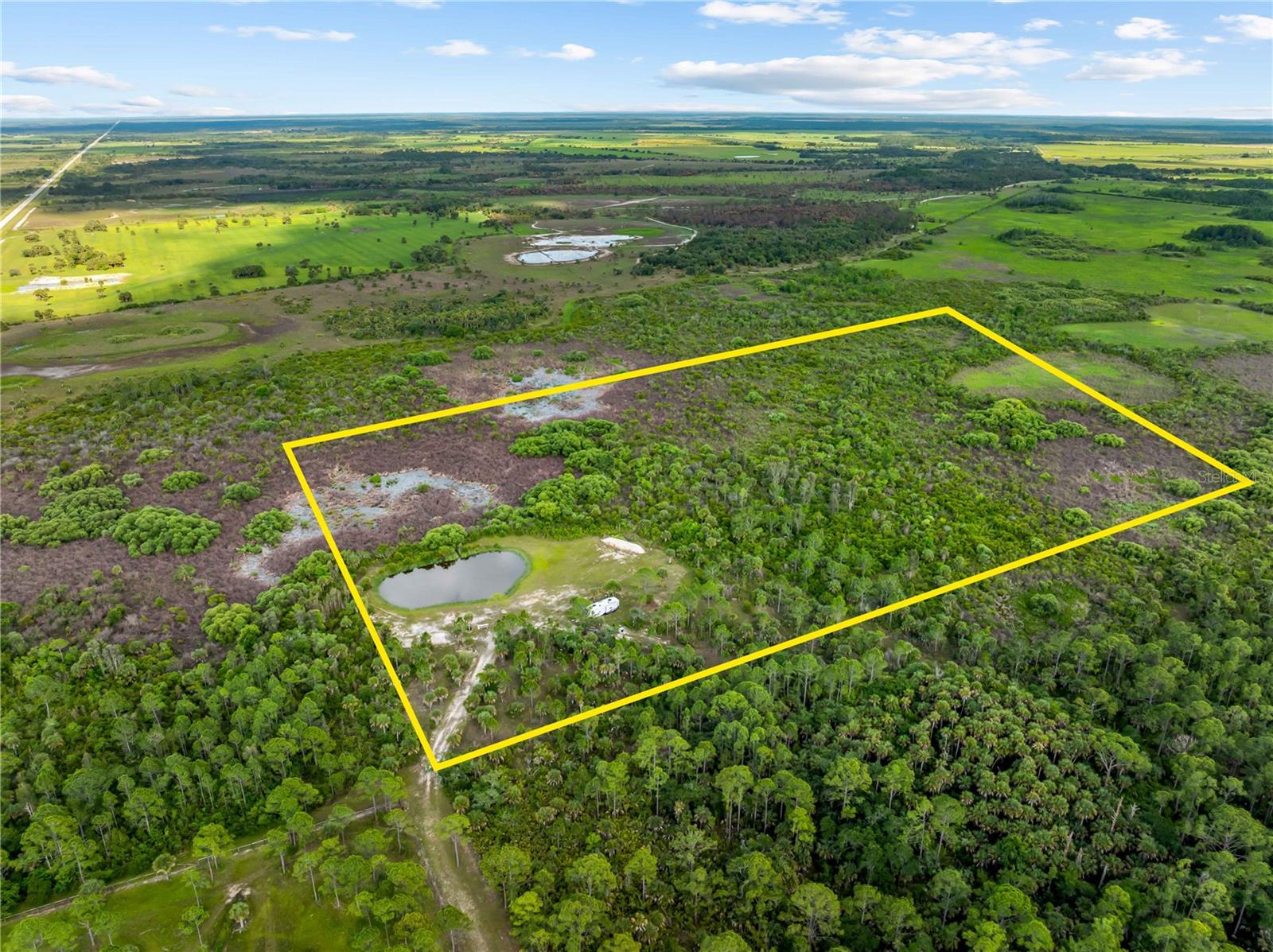 Are you looking for an escape? Are you looking for some privacy? Maybe some hunting?  How about a place to shoot without having to go to the range?  You owe it to yourself to look into this listing a little further.  10 Acres in Punta Gorda, just off of Bermont Road.  The property has its own lake.  A portion of the parcel is cleared with fill and manicured.  Built a cabin or build a mansion.  If a fifth wheel is enough, the one in the pictures is available (for an additional charge) and the bathroom has never been used!