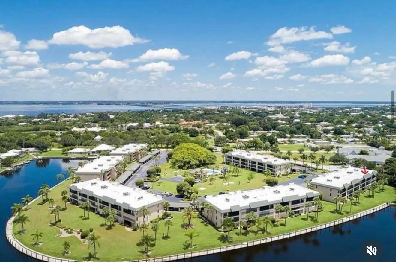 Virtually Staged. BEAUTIFUL FIRST-FLOOR CONDOMINIUM  OVERLOOKING THE  CANAL. Enjoy the ease of first-floor waterfront living in this inviting Punta Gorda condo, where  canal views, a peaceful greenbelt, and walk-out access create a relaxing coastal retreat. Start your morning on the screened lanai overlooking the water, then step outside to enjoy the waterfront setting. Positioned beside the greenbelt, this residence offers added privacy, natural light, and an inviting connection to the outdoors—perfect for morning coffee, gathering with friends, or unwinding after a day on the water.  The spacious primary suite features canal views, sliding glass doors opening directly to the lanai, a walk-in closet, and an oversized ensuite bath with dual vanities. With no stairs to navigate, this home is well suited for a seasonal getaway or full-time residence. Community amenities include a swimming pool that is both heated and cooled, and dock space available, this is a boater's dream. Location, Location,Location... this puts you within walking distance to historic downtown Punta Gorda, Fishermen’s Village, Gilchrist Park, the History Park Farmers Market, waterfront dining, boutique shopping, live music, and entertainment. Nearby walking and biking paths offer even more ways to explore and enjoy the area. Schedule your tour today!!